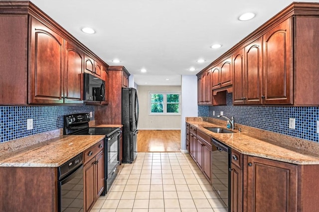 10 Freedom Holw Unit 10, Salem, MA 01970 - kitchen with black appliances, light tile patterned floors, backsplash, and recessed lighting