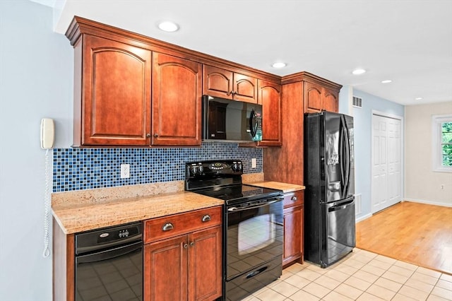 10 Freedom Holw Unit 10, Salem, MA 01970 - kitchen with black appliances, backsplash, light stone counters, recessed lighting, and light tile patterned floors