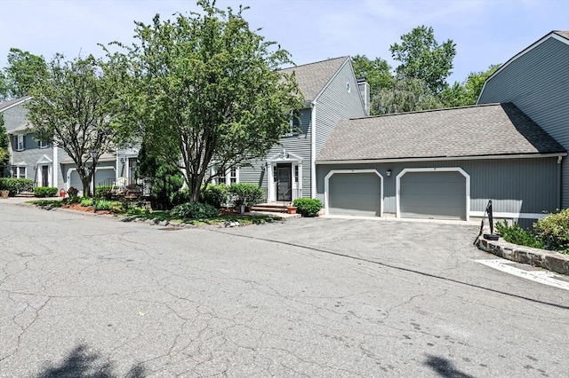 10 Freedom Holw Unit 10, Salem, MA 01970 - view of front of house featuring a garage, asphalt driveway, and roof with shingles