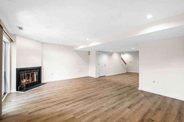 10 Freedom Holw Unit 10, Salem, MA 01970 - unfurnished living room with light wood-style floors, stairway, recessed lighting, and a multi sided fireplace