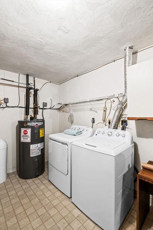 10 Freedom Holw Unit 10, Salem, MA 01970 - laundry room featuring electric water heater, washer and clothes dryer, light flooring, and a textured ceiling