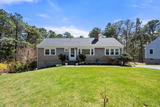 ranch-style home featuring a front lawn, a chimney, and entry steps