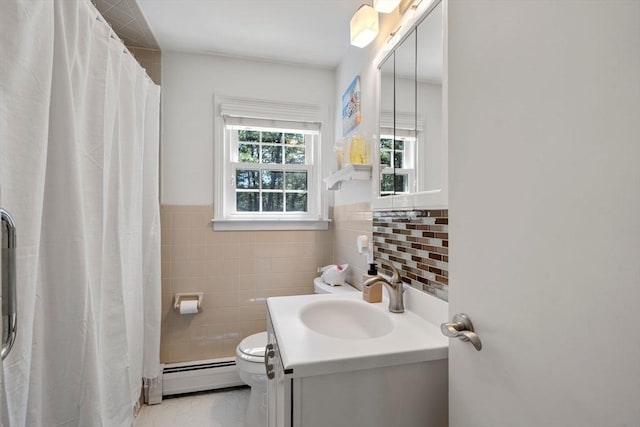 bathroom with vanity, toilet, tile walls, a baseboard radiator, and a shower with curtain