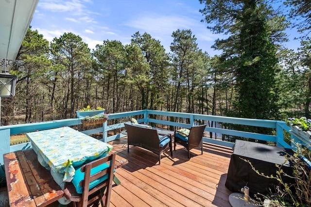 wooden terrace with outdoor dining area