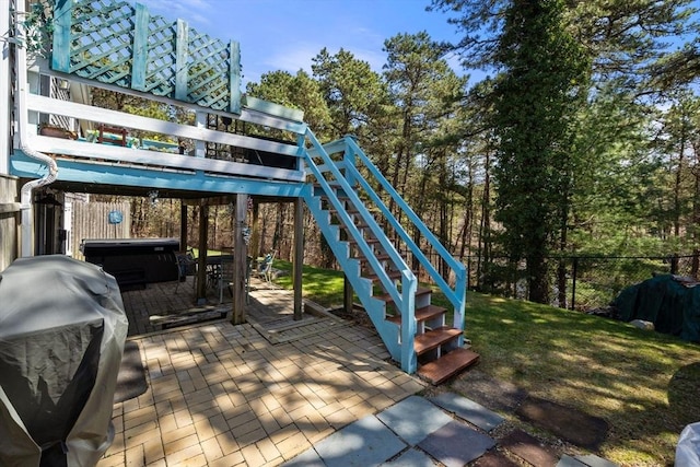 exterior space with stairs, a patio, and a hot tub