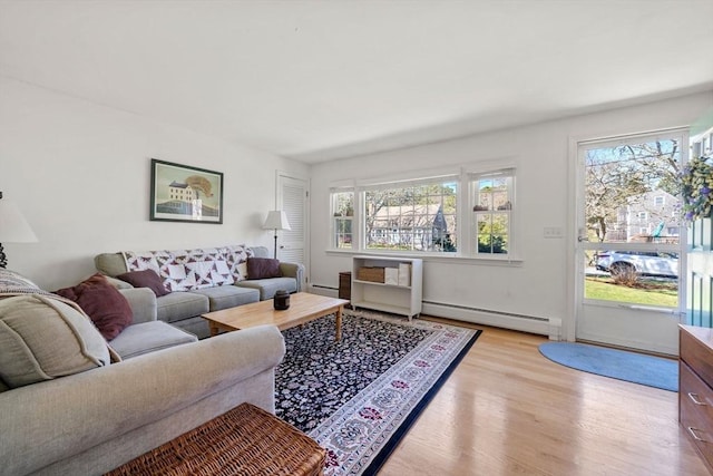 living room with a baseboard heating unit, light wood-style flooring, and a baseboard radiator