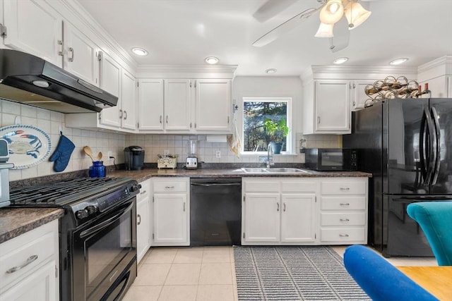 kitchen with under cabinet range hood, black appliances, and dark countertops