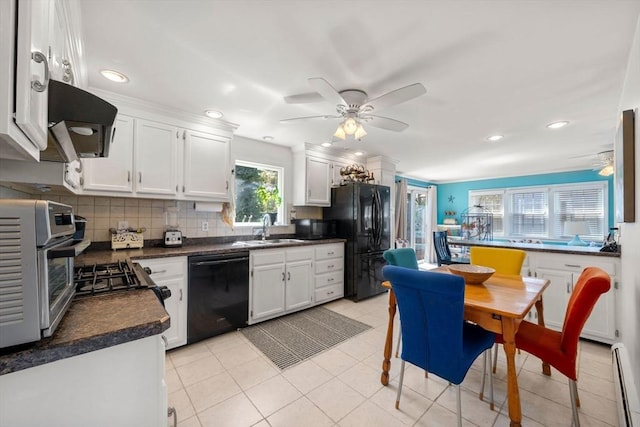 kitchen featuring backsplash, a ceiling fan, dark countertops, black appliances, and under cabinet range hood
