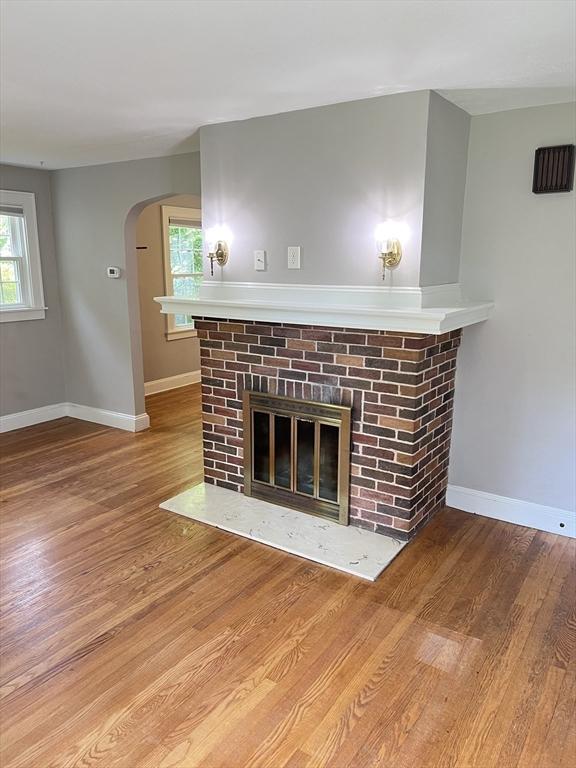 65 Franklin Rd, Longmeadow, MA 01106 - detailed view of a brick fireplace, wood finished floors, and arched walkways