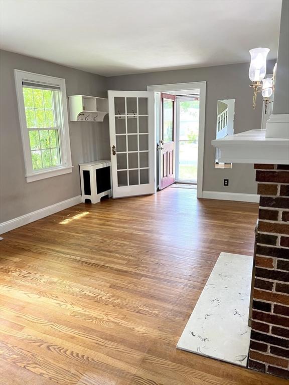 65 Franklin Rd, Longmeadow, MA 01106 - unfurnished living room featuring baseboards and wood finished floors