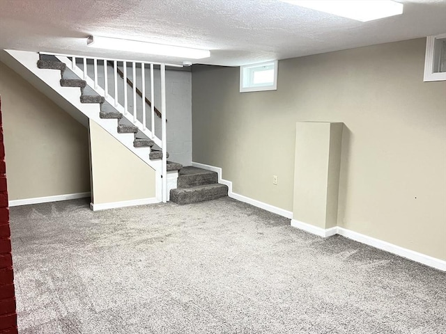 65 Franklin Rd, Longmeadow, MA 01106 - below grade area featuring a textured ceiling, stairs, and carpet