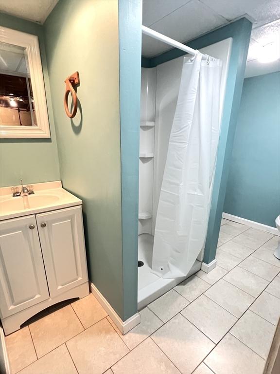 65 Franklin Rd, Longmeadow, MA 01106 - full bathroom featuring vanity, tile patterned floors, and a shower stall