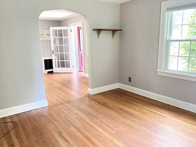 65 Franklin Rd, Longmeadow, MA 01106 - unfurnished room with arched walkways, plenty of natural light, and light wood-style floors