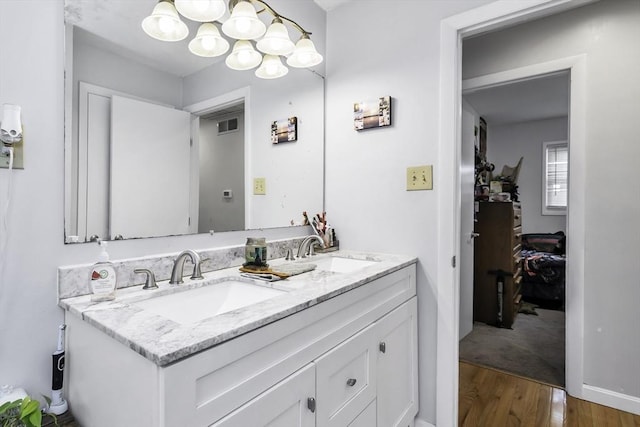 17 Barnard Rd, Lawrence, MA 01843 - bathroom with double vanity, wood finished floors, and a chandelier