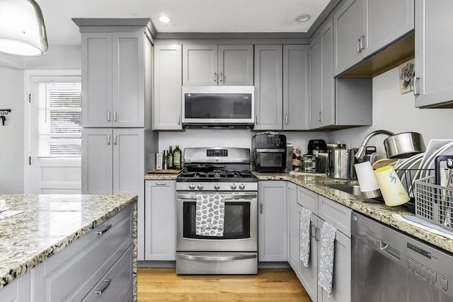 17 Barnard Rd, Lawrence, MA 01843 - kitchen featuring stainless steel appliances, gray cabinets, light wood-type flooring, light stone counters, and recessed lighting
