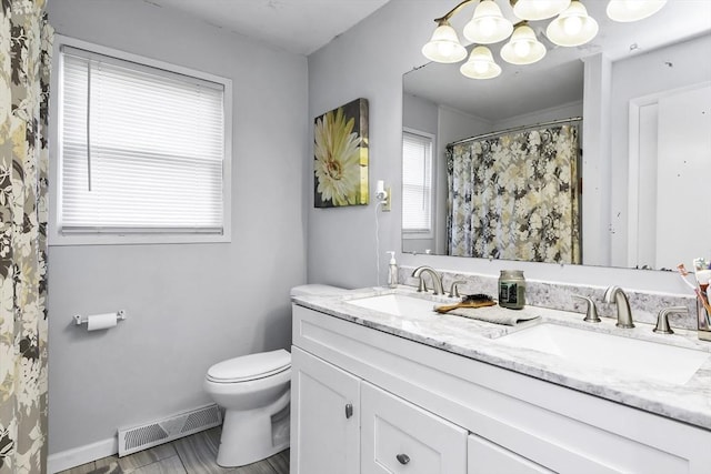 17 Barnard Rd, Lawrence, MA 01843 - full bathroom with toilet, double vanity, a chandelier, baseboards, and a shower with curtain
