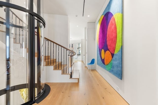 entryway with light hardwood / wood-style floors and a healthy amount of sunlight