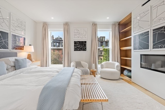 bedroom featuring light wood-type flooring and multiple windows