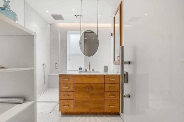 bathroom with vanity, tile patterned floors, and walk in shower