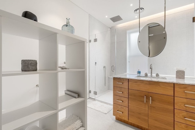 bathroom with vanity, tile patterned flooring, and a shower with door