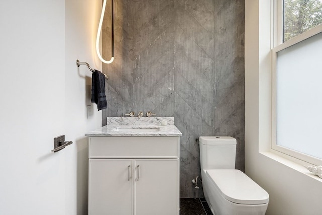 bathroom featuring vanity and toilet