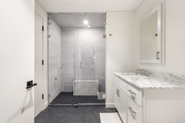 bathroom featuring tile patterned flooring, vanity, and walk in shower