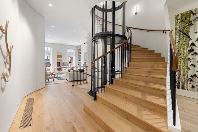 staircase featuring hardwood / wood-style floors