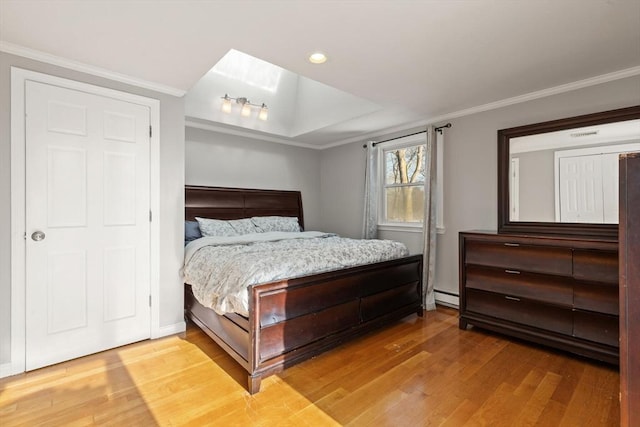 bedroom featuring a baseboard radiator, ornamental molding, and wood-type flooring