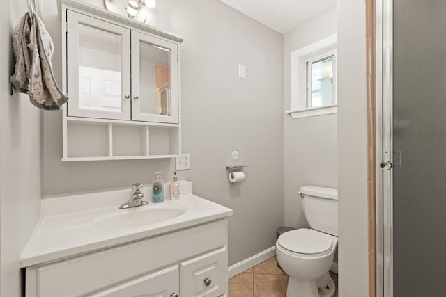 bathroom featuring tile patterned flooring, vanity, an enclosed shower, and toilet