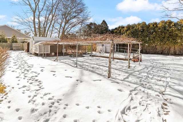 yard covered in snow featuring an outdoor structure