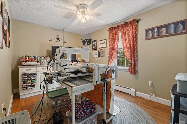 77 Center St, Ashburnham, MA 01430 - home office featuring a baseboard heating unit, a ceiling fan, wood finished floors, a textured ceiling, and baseboards