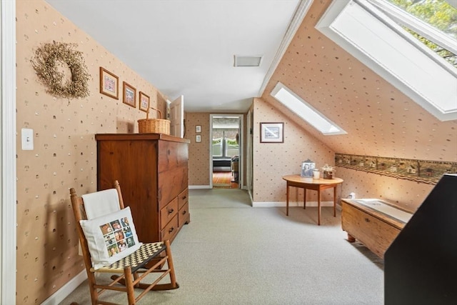 77 Center St, Ashburnham, MA 01430 - living area featuring a skylight, wallpapered walls, lofted ceiling, light colored carpet, and baseboards
