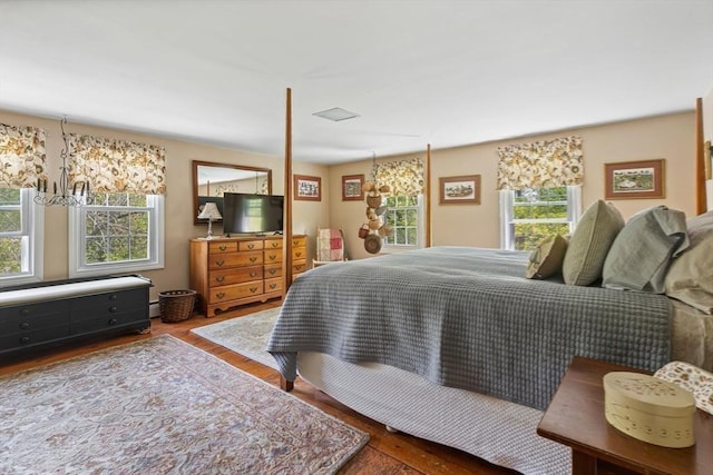 77 Center St, Ashburnham, MA 01430 - bedroom featuring multiple windows, wood finished floors, and a baseboard heating unit