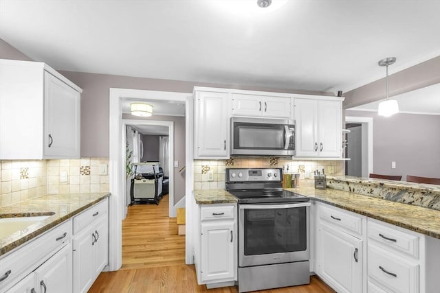2 Ridge Rd, East Longmeadow, MA 01028 - kitchen with stainless steel appliances, white cabinets, and decorative backsplash