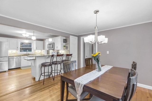 2 Ridge Rd, East Longmeadow, MA 01028 - dining space with a chandelier, light wood-type flooring, ornamental molding, and baseboards