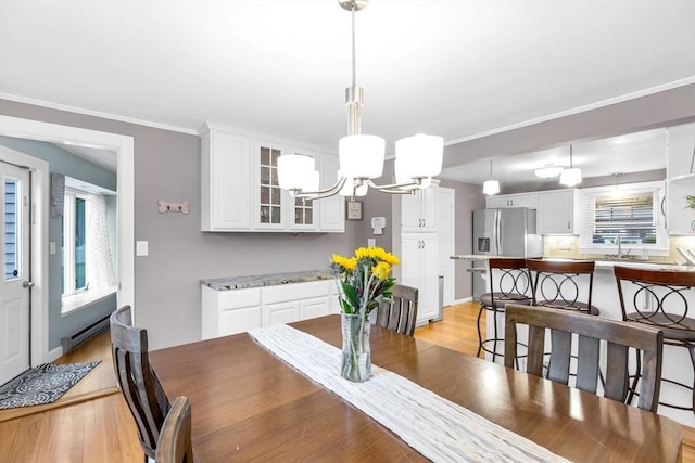 2 Ridge Rd, East Longmeadow, MA 01028 - dining space with light wood-style flooring, a chandelier, crown molding, and a baseboard radiator