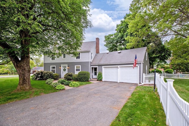 2 Ridge Rd, East Longmeadow, MA 01028 - colonial-style house with an attached garage, asphalt driveway, and a chimney