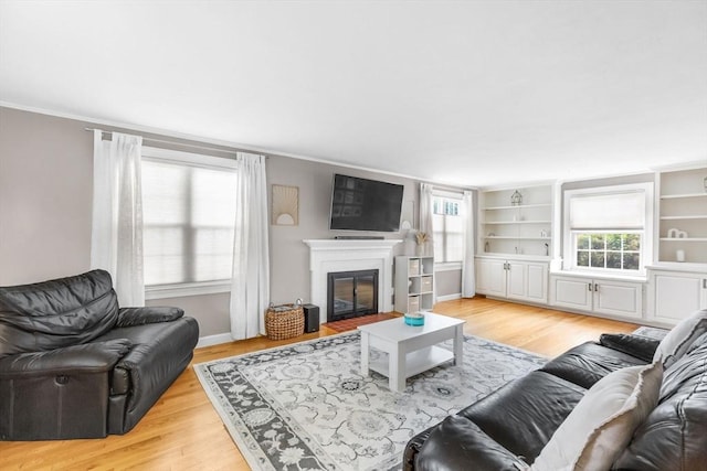 2 Ridge Rd, East Longmeadow, MA 01028 - living room with a glass covered fireplace, light wood finished floors, crown molding, baseboards, and built in features