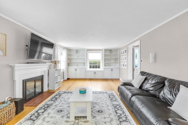 2 Ridge Rd, East Longmeadow, MA 01028 - living room with light wood-type flooring, a brick fireplace, built in shelves, and crown molding