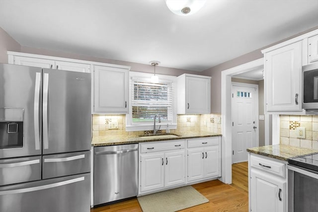 2 Ridge Rd, East Longmeadow, MA 01028 - kitchen with stainless steel appliances, a sink, stone counters, and white cabinets