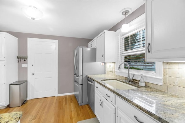 2 Ridge Rd, East Longmeadow, MA 01028 - kitchen featuring a sink, stainless steel dishwasher, light wood-style floors, and decorative backsplash