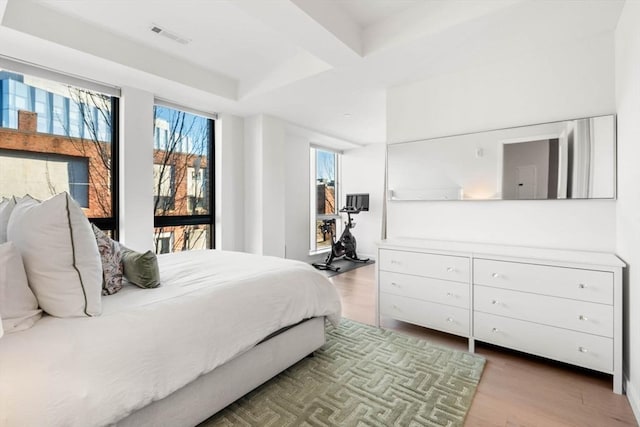 bedroom featuring visible vents and wood finished floors