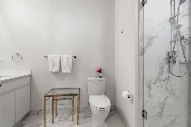 bathroom featuring marble finish floor, vanity, a marble finish shower, and toilet