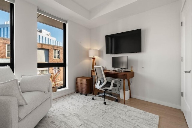 office featuring baseboards and wood finished floors