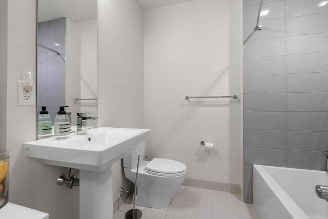 full bathroom with baseboards, toilet, and tile patterned floors