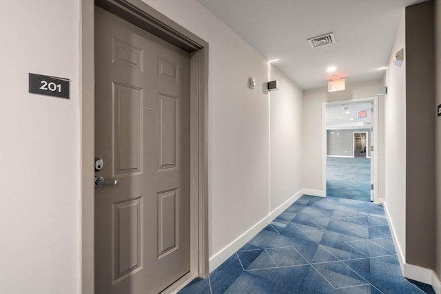 corridor featuring visible vents and baseboards