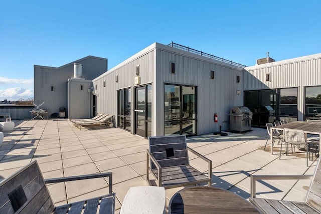 view of patio / terrace featuring outdoor dining area and a grill