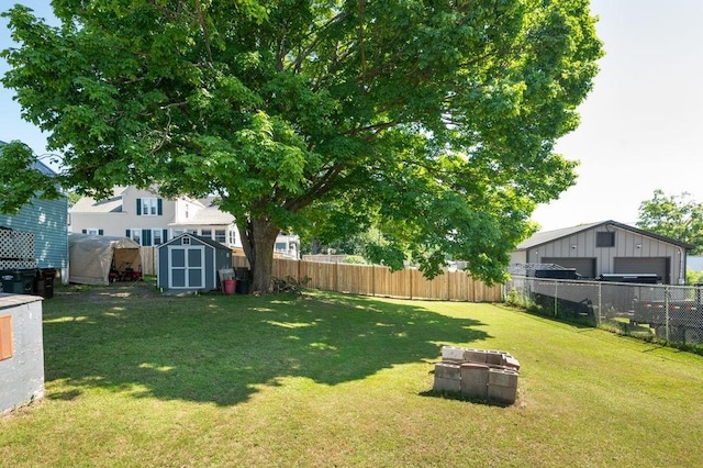 17-19 Whitehall Rd, Amesbury, MA 01913 - fenced backyard with a shed and a detached garage