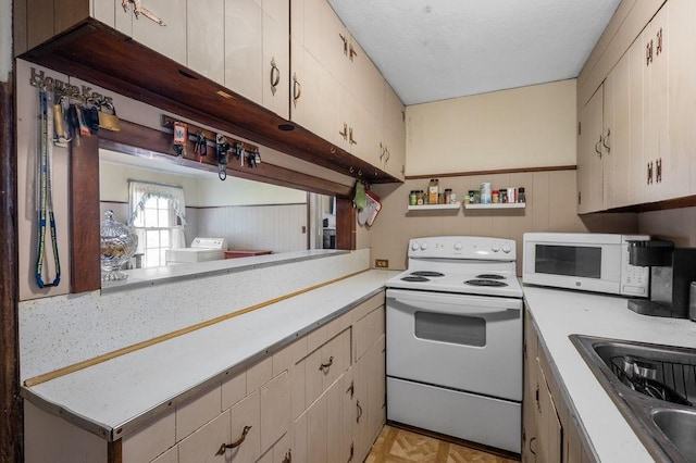 17-19 Whitehall Rd, Amesbury, MA 01913 - kitchen featuring white appliances, light countertops, and washer / clothes dryer