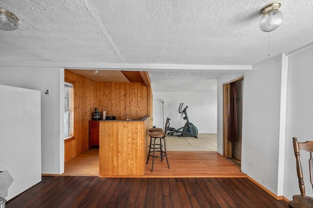 17-19 Whitehall Rd, Amesbury, MA 01913 - kitchen with a textured ceiling, wood finished floors, and wooden walls